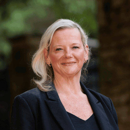 Professional woman outdoors in a business setting for Payer Strategy and Contracting.