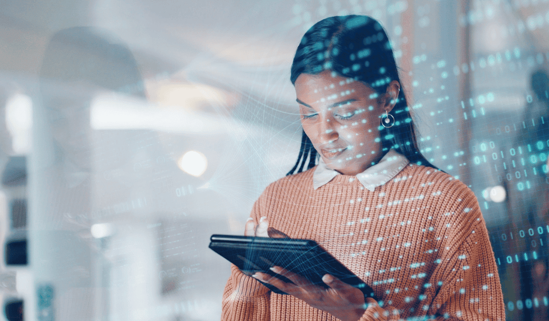 Young woman engaging with digital tablet and data visualization in modern office.